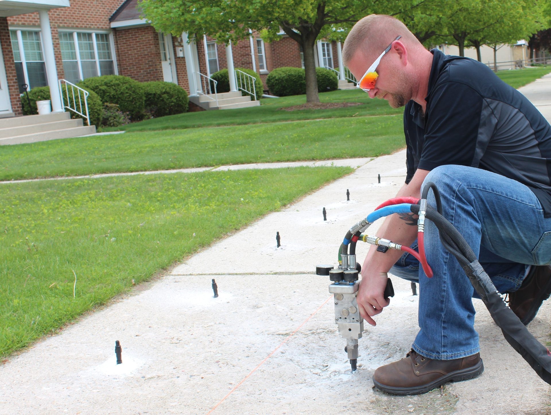 HMI certified technician injecting foam beneath concrete slab